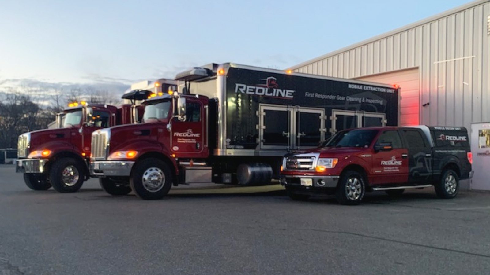 Fleet of Mobile Extraction Units parked in front of building
