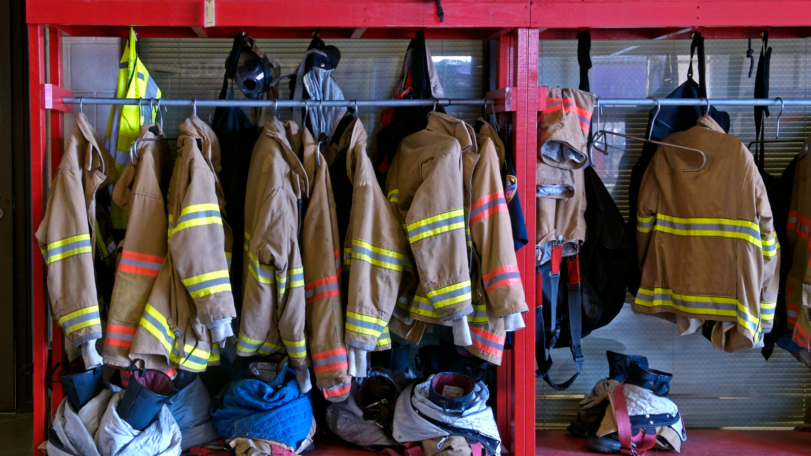 Firefighters jackets hanging in firehouse
